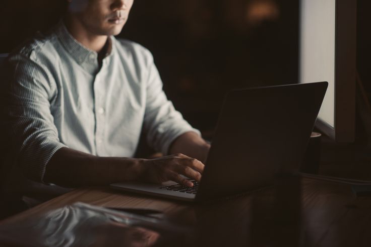 a man researching how to get money back from a scammer on his computer