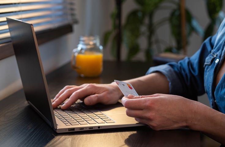 Man inputting card details on laptop